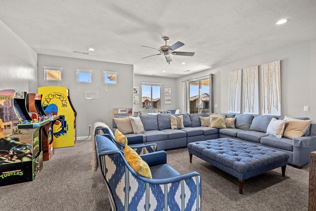 Upstairs loft with sectional sofa and arcade game cabinets