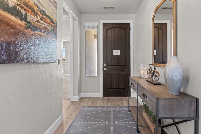 Entry hallway with front door, console table and mirror