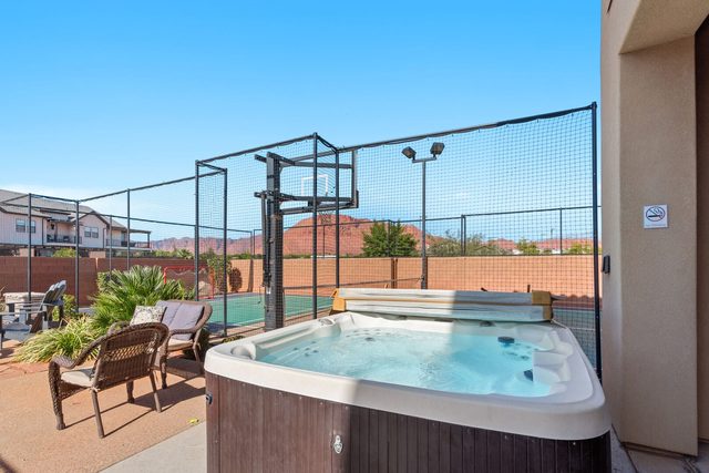 Private hot tub on the patio beside the sports court