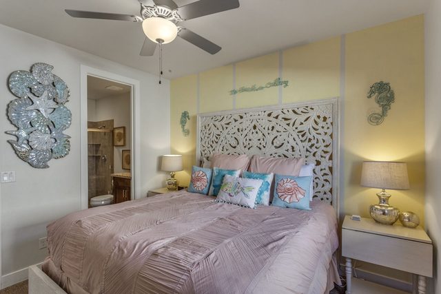 Seahorse Suite king bed with carved white headboard and ensuite
