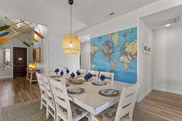 Dining table for eight beneath a world map wall mural