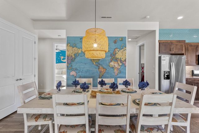 Dining area with world map mural opening to the kitchen