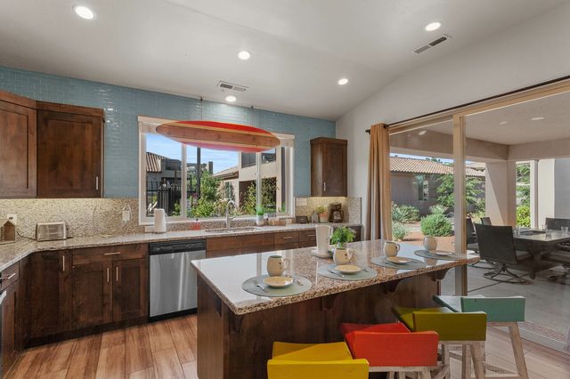Kitchen island bar seating with view to the covered patio