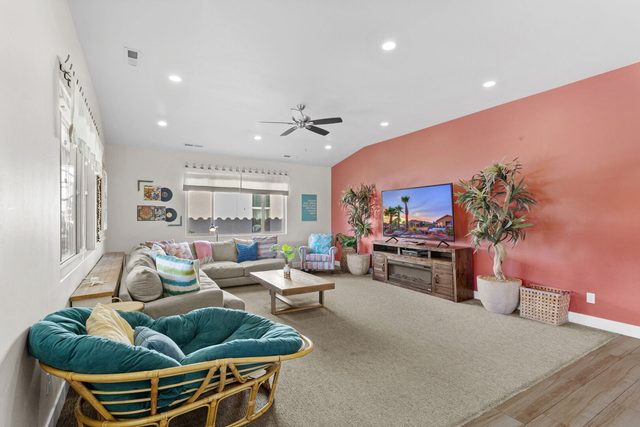 Beach-themed living room with sectional, papasan chair and smart TV