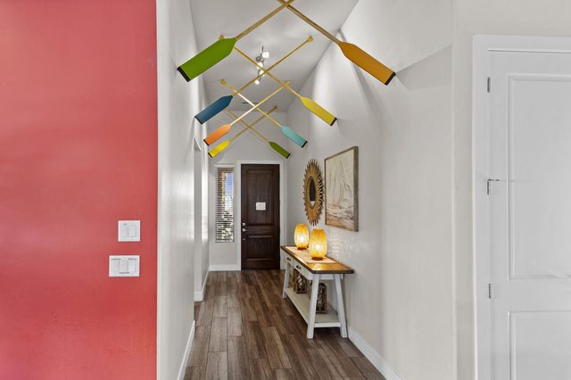 Entry hallway with colorful paddle wall art and console table