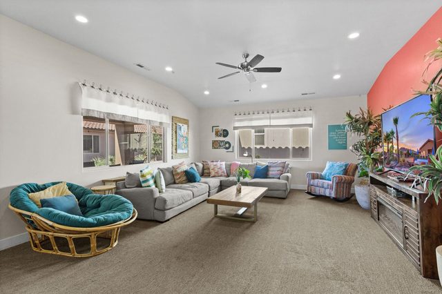 Bright living room with sectional sofa, papasan chair and TV