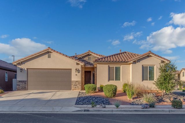 Single-story front exterior with two-car garage at Paradise Village 111