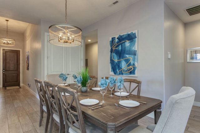 Dining table with chandelier and seating for a group