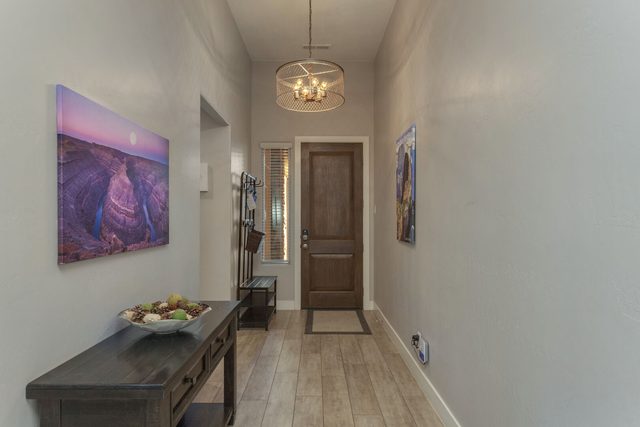 Entry hallway with console table and wood-look tile floors
