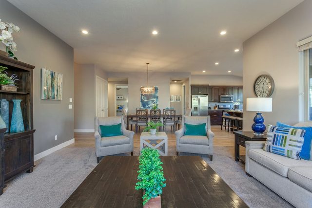 Open great room looking toward the dining area and kitchen