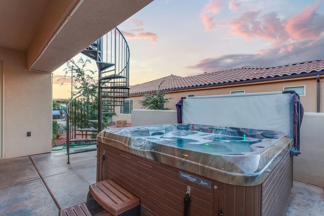 Private hot tub with steps next to the spiral staircase