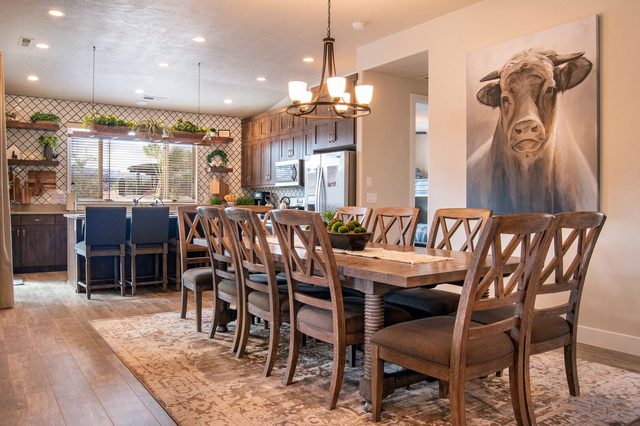Dining table for ten with chandelier beside the kitchen bar
