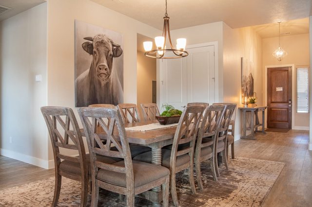 Dining table with upholstered chairs near the front entry
