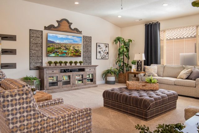 Living room with two sofas, tufted ottoman and TV console