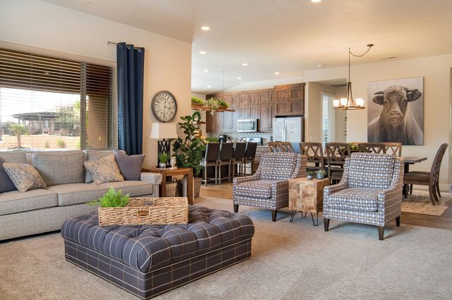 Great room with sofas and armchairs opening to the dining area