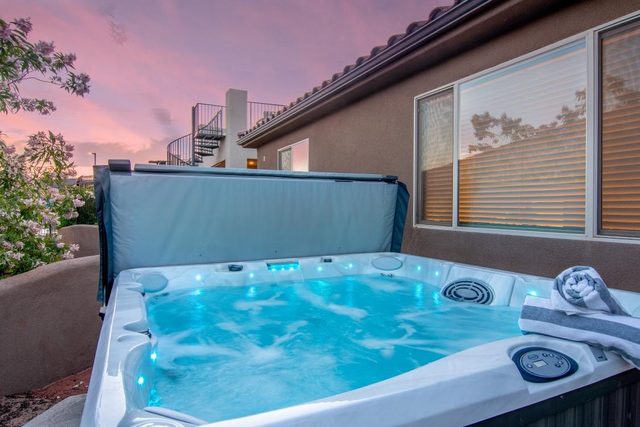 Private hot tub on the back patio of Paradise Village 113 at sunset