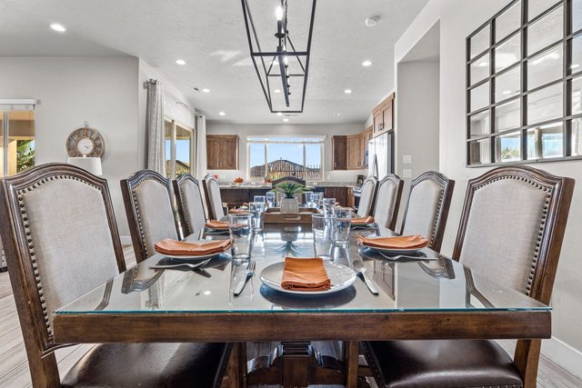 Dining table set for a group dinner under modern chandelier