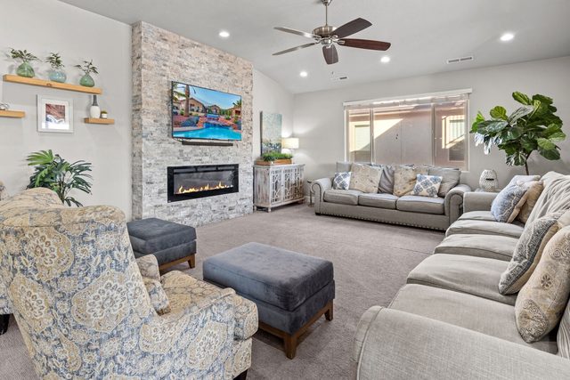Family room with linear fireplace, large TV and ample seating