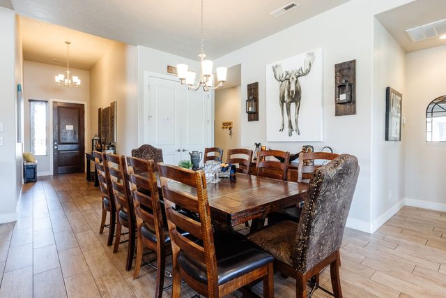 Long wood dining table with seating for twelve near the entry