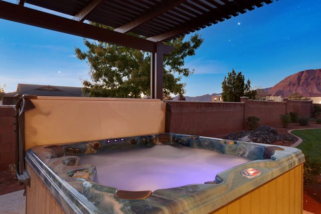Private hot tub under a pergola with red rock views