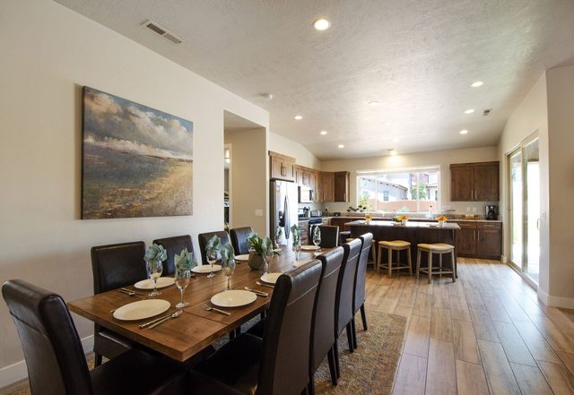 Dining table for ten opening to the kitchen and bar seating