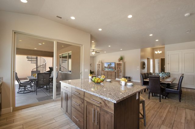 Kitchen island beside sliding doors to the covered back patio