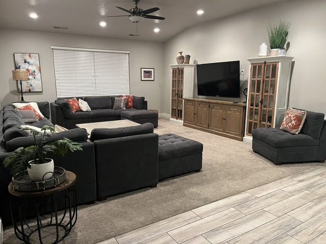 Living room with large sectional sofa and TV cabinet