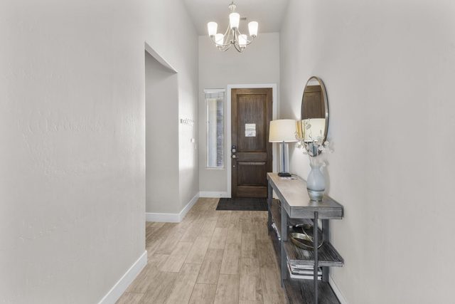 Entry hallway with wood front door and console table