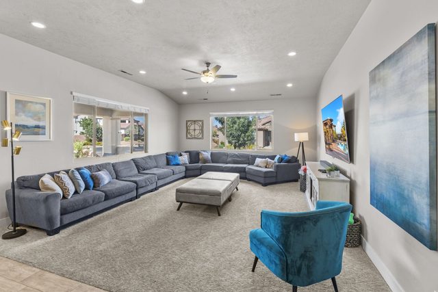 Long living room with wraparound sectional and blue accent chair