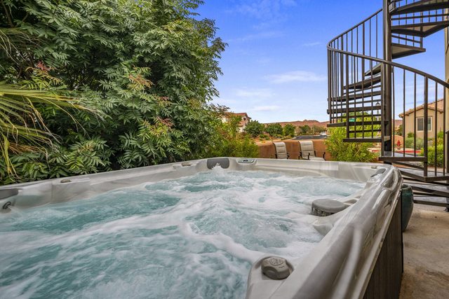 Private hot tub beside the spiral stairs at Paradise Village 121