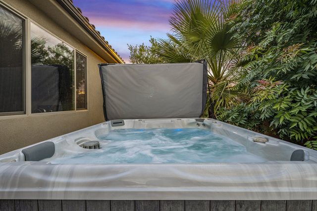 Private hot tub surrounded by palms at twilight