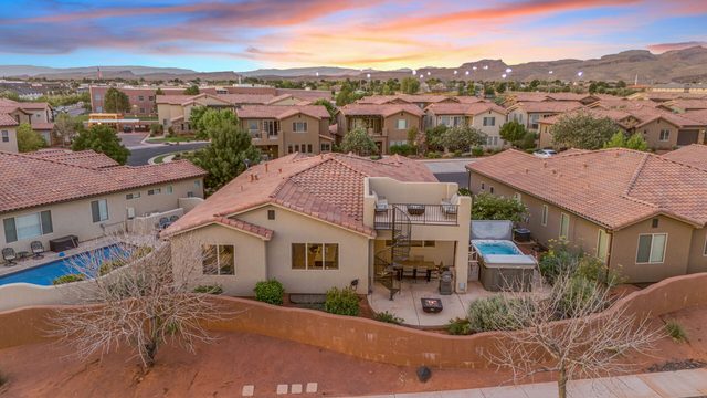 Aerial of the home's rear patio, swim spa and rooftop lounge