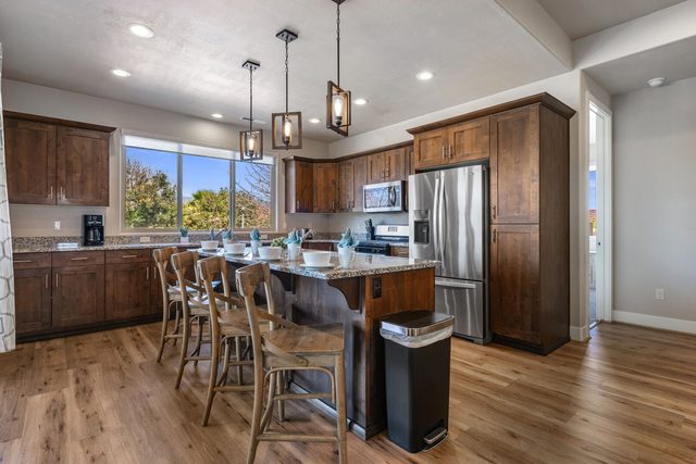 Kitchen island with bar seating and stainless steel appliances
