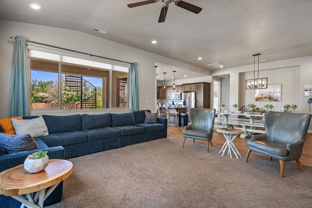 Open living room with sectional, armchairs and dining area beyond