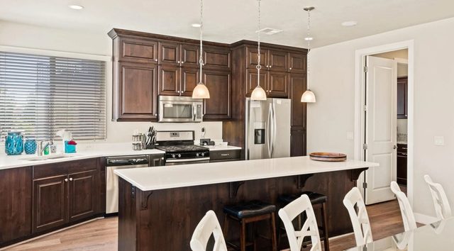 Unit 18 kitchen with island bar seating and stainless appliances