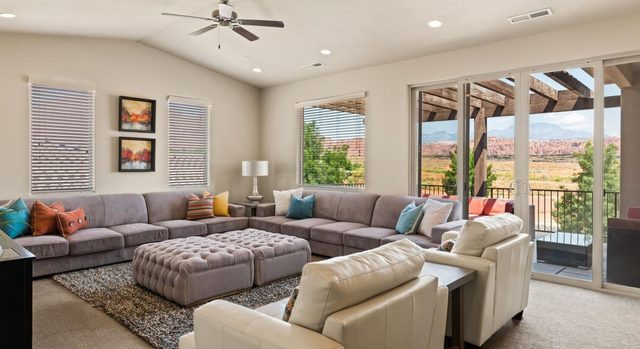 Unit 18 upstairs living room with sectional and red rock views