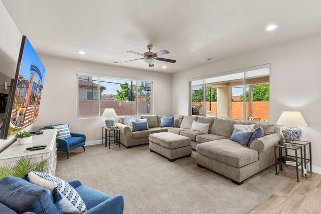 Unit 19 living room with sectional and large wall TV