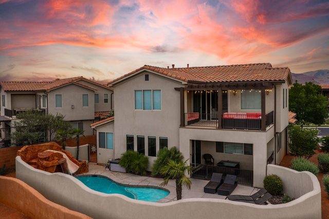 Rear exterior of Paradise Village 18 with walled pool yard