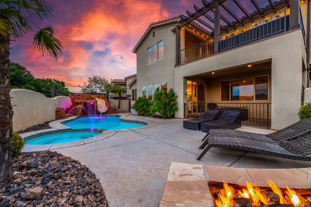 Private pool and loungers behind Paradise Village 18 at dusk