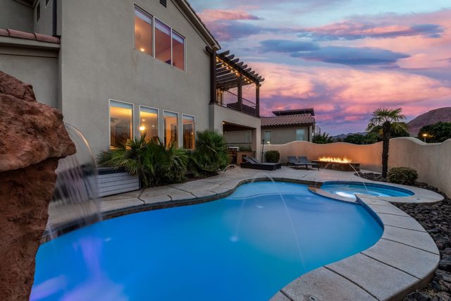 Private heated pool with waterfall and backyard fire pit