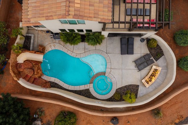 Aerial of private pool, hot tub, slide and fire pit