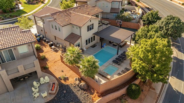 Aerial of the home with backyard pool and pergola
