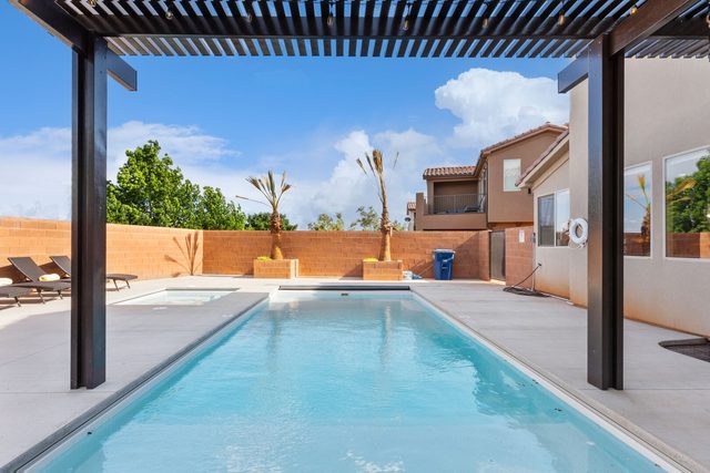 Private pool under the pergola with lounge chairs
