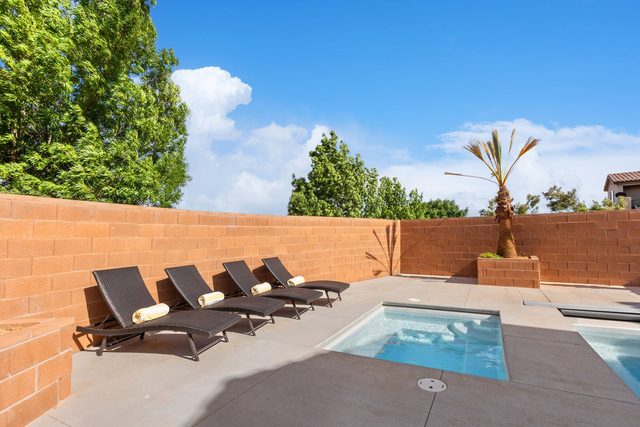 Private spa and sun loungers along the backyard wall