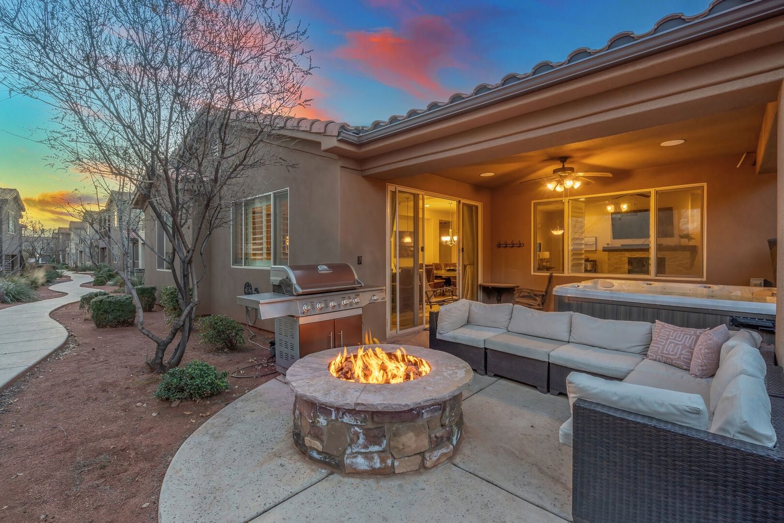 Covered patio with sectional, fire pit and grill at dusk, Paradise Village 28
