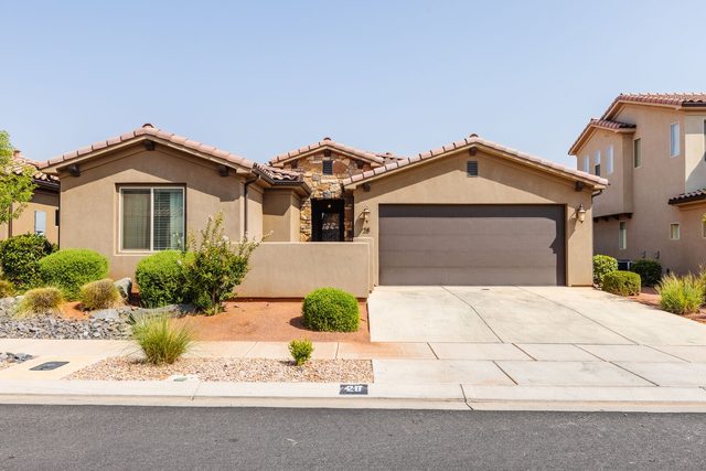 Front of single-level Paradise Village 28 home with two-car garage