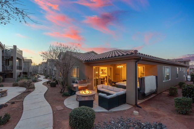 Rear of Paradise Village 28 with lit patio and fire pit