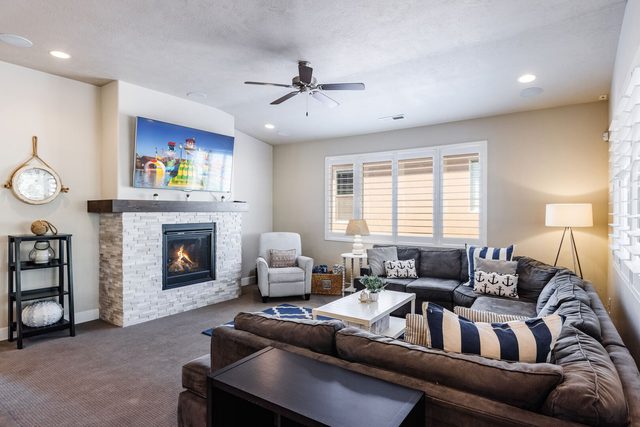 Living room with fireplace, sectional and wall TV at Paradise Village 28