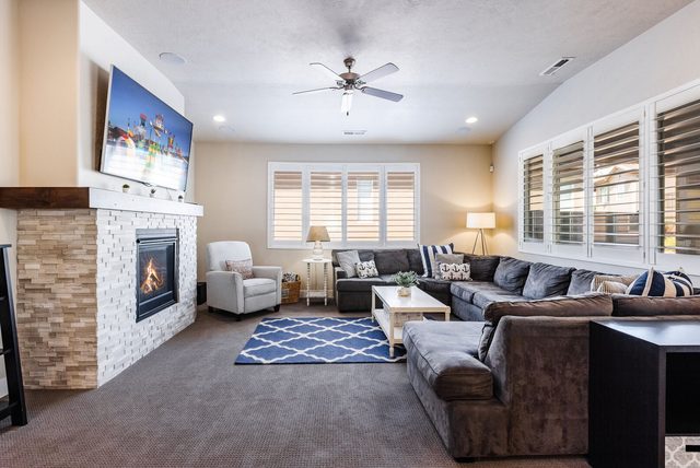 Living room with stone fireplace and large sectional at Paradise Village 28