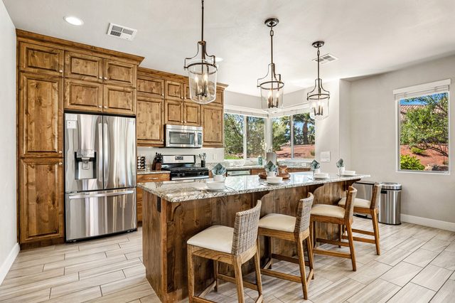 Home 31 kitchen island with bar stools and stainless appliances